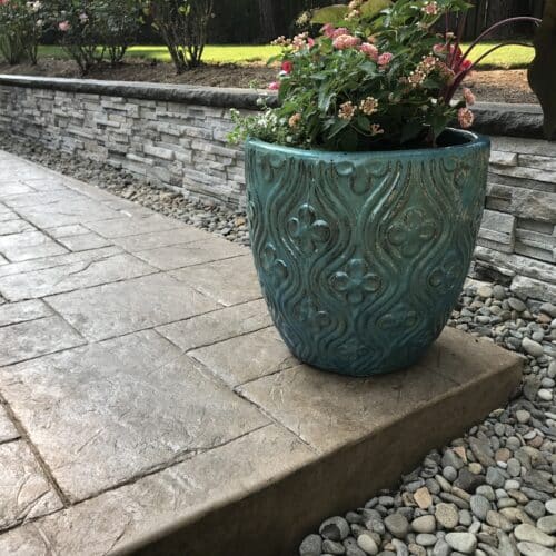 CONCRETE PATIO AND STONE WALL